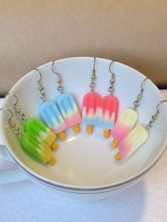 four popsicle shaped key chains in a bowl