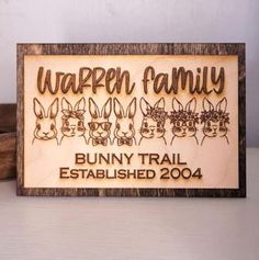 a wooden sign that says,'bunny trail established in 1994'with rabbits on it