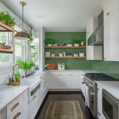 the kitchen is clean and ready for us to use it's green accent wall