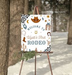 an easel with a welcome sign in the snow