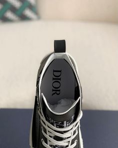 Embrace a blend of classic and contemporary style with these high-top sneakers inspired by the iconic Dior B23. Featuring a sleek black upper adorned with the signature Dior Oblique pattern, these shoes exude understated luxury. The contrasting white sole with a black stripe adds a sporty touch, while the high-top silhouette provides ankle support and a fashion-forward edge. Dior Oblique, Understated Luxury, Loafer Sneakers, Ankle Support, Bottega Veneta Shoulder Bag, Loafer Shoes, Black Stripes, High Top, Top Sneakers