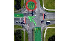 an aerial view of a traffic intersection with arrows pointing in different directions