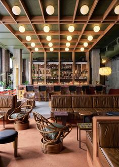 the bar is decorated with wicker chairs and leather couches, along with other furniture