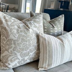 the pillows on the couch are all different colors and patterns, but one is white