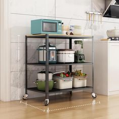 a kitchen area with a microwave and various food items on the shelf next to it