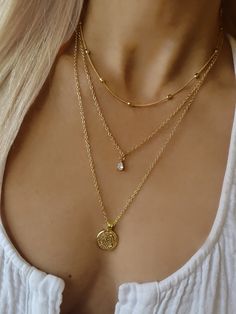 ★ ★ ★FREE SHIPPING ★ ★ ★ PRODUCT DESCRIPTION A lovely trio of gold necklace set with coin and zircon charm to wear in the popular layered style. This minimal style Layer up your look with bright pearls and gold. These pieces have 3x layers of solid 18k gold and are 100x times more resistant than regular gold plated. MEASUREMENT AND SIZE (on the model) This set comes with 2 inches extender chain ✦The length of the 1st necklace is 16 inches (42cm) ✦The total length of the 2nd necklace is 18 inches Necklace Combos, Jewellery Stacking, Coin Necklace Gold, 3 Layer Necklace, Necklace Set Gold, Layered Coin Necklace, Gold Layered Necklace, Necklace Combo, Star And Moon Necklace