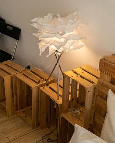 a lamp that is sitting on top of some wooden crates in a room filled with furniture