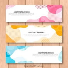 three abstract banners on wooden background with dots and circles in different colors, shapes and sizes