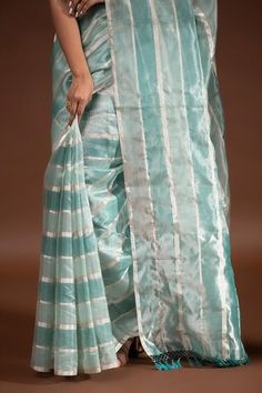 Mint blue handloom banarasi saree with stripe pattern. Comes along with unstitched blouse piece. - Aza Fashions Eid Blue Cotton Silk Pre-draped Saree, Transitional Blue Cotton Silk Pre-draped Saree, Blue Tissue Silk Blouse Piece For Transitional Season, Blue Slub Silk Pre-draped Saree With Self Design, Blue Cotton Silk Pre-draped Saree, Blue Handloom Tissue Silk Blouse Piece, Blue Slub Silk Blouse Piece With Self Design, Blue Handloom Tissue Silk Traditional Wear, Blue Tissue Silk Blouse Piece With Self Design