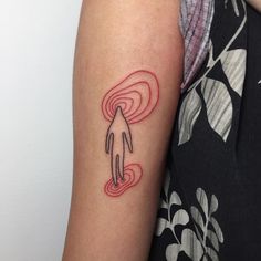 a woman's arm with a tattoo on it that has an image of a hand