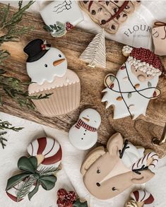 decorated christmas cookies sitting on top of a wooden table