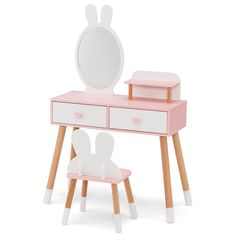 a pink and white desk with a mirror, stool and toy rabbit head on it