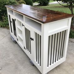 a white kitchen island with wooden top on wheels