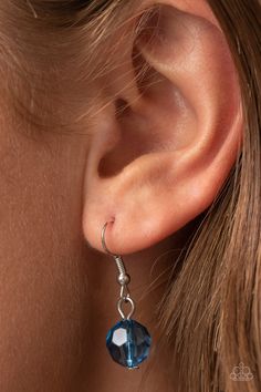 a woman's ear is shown with a pair of earrings in the shape of a heart