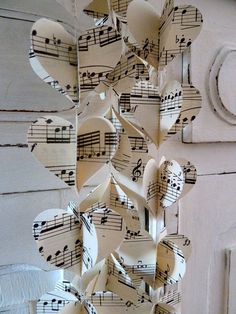 a bunch of sheet music notes hanging from the side of a door