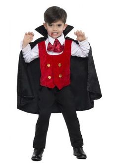 a young boy dressed in a dracula costume