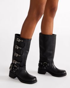 The ROCKY knee boot features the wide profile of an engineer boot with harness and buckle hardware adding an industrial edge and giving the design an adjustable fit. Block heel engineer boot Slip-on style Top gore with 4 adjustable buckle straps 2 inch heel height Size 6 measurements: 14.5 inch shaft circumference, 12.5 inch shaft height Size 8 measurements: 15 inch shaft circumference, 13 inch shaft height Size 10 measurements: 16 inch shaft circumference, 13.5 inch shaft height Leather upper m Platform Slip Ons, Summer Wardrobe Staples, Engineer Boots, Waterproof Sneakers, An Engineer, Leather Wear, Knee Boot, Flat Sneakers, Sneaker Heels