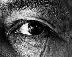 an old man's eye is shown in black and white