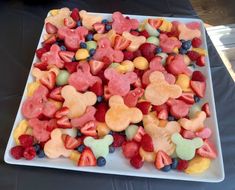 a white plate topped with lots of cut up fruit