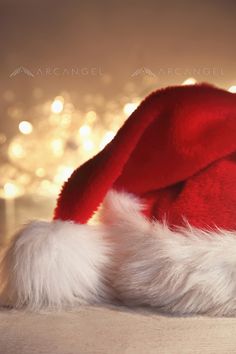 a red and white santa hat sitting on top of a table