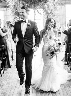 a bride and groom walking down the aisle