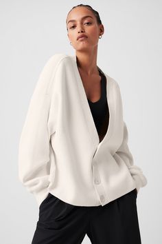 A classic piece you’ll wear constantly, the Scholar is knit from a soft, heavyweight cotton blend with just-right drape. It has an oversized fit, a four-button front, dropped shoulders and cozy ribbed cuffs. Wear it as a throw-on-and-go layer with your favorite workout sets, or style it with trousers and heeled boots for a dressed-up dinner date. Oversized Cardigan Outfit, Oversized White Cardigan, Sweatpants And Sweater, Airplane Outfits, Sweatshirt Cardigan, Gray Accessories, Winter Must Haves, Linen Sweater, Manifestation Board