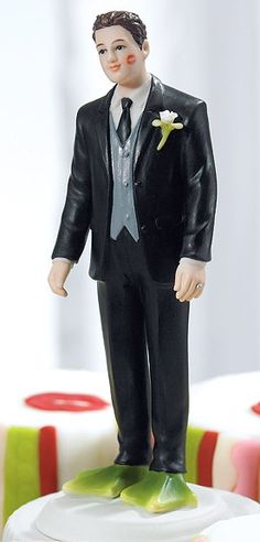 a figurine of a man in a suit and tie on top of a cake