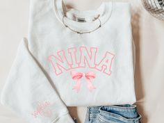 This custom nina sweatshirt is a great gift for a nina or new nina to be! This sweatshirt can be given as a gift to a friend or loved one for Mother's Day or as a baptismal gift for a godmother. This sweatshirt is made with the highest quality materials and is super comfy, soft and cozy!! Please enter the name(s) of child(ren) you would on the sleeve in the personalized section. ABOUT THIS ITEM: - Gildan Sweatshirt - Long Sleeve Crew Neck - Ribbed Neck Collar - Double-Needle Stitching - Not Viny Coquette Clothing, Printing Shirt, Vinyl Printing, Gildan Sweatshirt, Godmother Gifts, Gildan Sweatshirts, Baptism Gifts, Fabric Print, Godmother