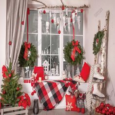 christmas decorations are displayed in front of a window