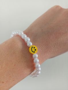 The Smiley Face Bracelet is so fun and happy! It's the perfect bracelet to wear on its own, or added to a stack of bracelets! Smiley Face Bracelet, Stack Of Bracelets, White Pearl Bracelet, Bracelet Pearl, Mud Mask, Plastic Resin, Smiley Face, White Pearl, Pearl Bracelet