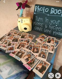 a table topped with pictures and a camera