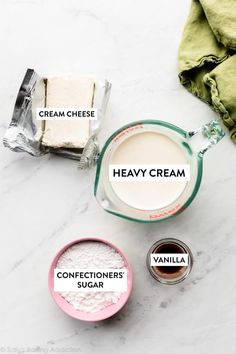 ingredients to make creamy cheesecakes on a marble countertop with text overlay