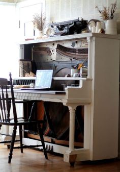 an old piano is sitting in front of a window