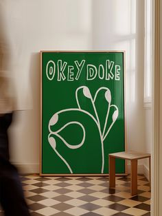 there is a green sign that says okay doke on the wall next to a small table