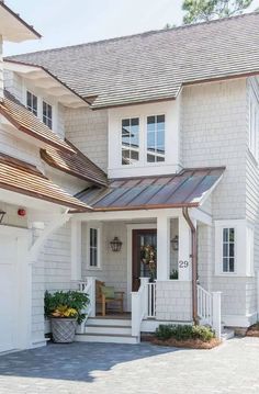 a white house with a brown metal roof