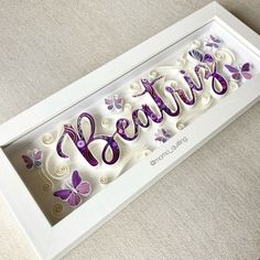 a white frame with purple butterflies and the words believe in it