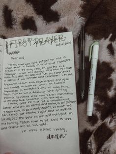 a handwritten letter and pen sitting on top of a leopard print blanket