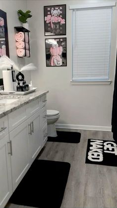 a bathroom with black and white rugs on the floor