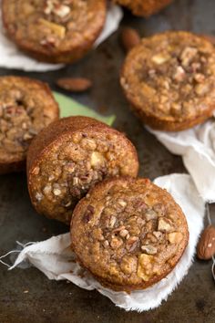 several muffins sitting on top of a table next to some napkins and nuts