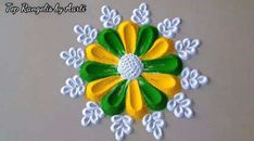 a yellow and green flower with white flowers on the center is featured in this handmade ornament