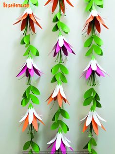 the paper flowers are hanging on the wall and ready to be made into garlands