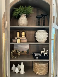 a book shelf filled with vases and other decorative items on top of each shelf