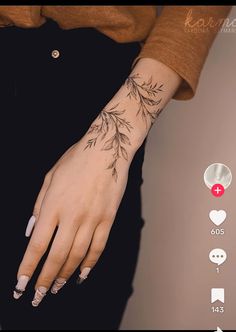 a woman's hand with tattoos on it