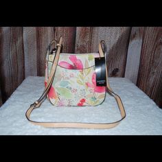 New With Tags. Floral Printed Leatherette. Adjustable Shoulder Strap. Lots Of Pockets. Center Zippered Pocket In Center Making Two Sides. One Inner Side Contains Zippered Pocket And Second Side Has Two Small Pockets On Side. Magnetic Snap Closure. Phone Pocket In Back. Spring Floral Print Crossbody Bag, Tan Shoulder Bag For Daily Use In Spring, Tan Everyday Bag For Spring, Spring Everyday Tan Bag, Tan Bag With Adjustable Strap For Spring, Tan Bags For Everyday Use In Spring, Tan Bag For Everyday Use In Spring, Tan Crossbody Bag For Spring, Strap Purse