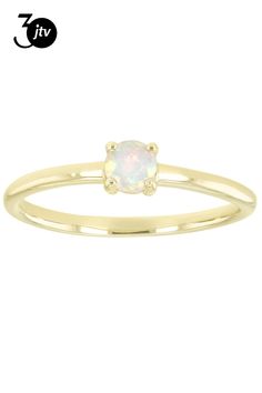 a yellow gold ring with an opal stone