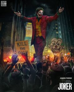 the joker movie poster with his arms out and hands in the air as he stands on stage