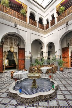 an indoor courtyard with tables and chairs