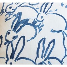 a blue and white pillow with rabbits on it