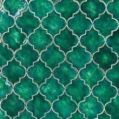 green and white tile with an intricate design on the outside, as seen from above