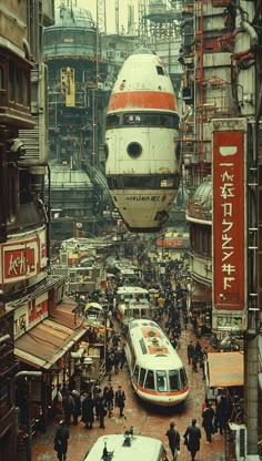 an overhead view of a train station with people walking around and cars parked on the street